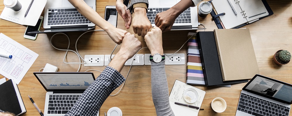 Colleagues giving a fist bump Colleagues giving a fist bump